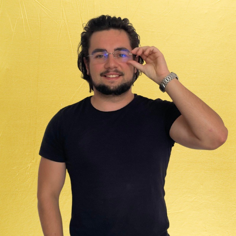 Un homme brun barbu sur fond jaune, Maxime Boutevillain